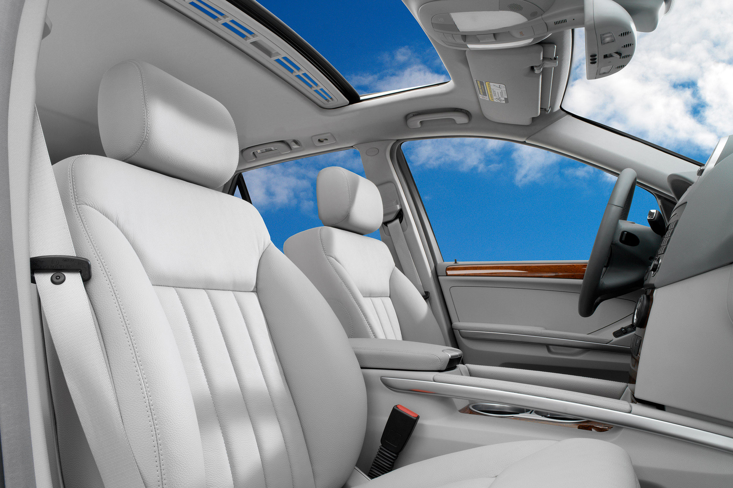 John Early High-End Digital Retouching - Interior View of SUV with White Seats Looking Out At Blue Skies